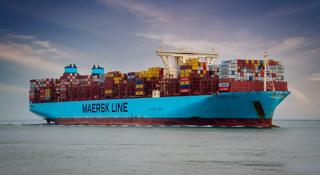 A ship fully loaded with containers is sailing at sea.